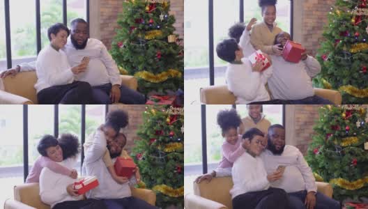 两个女儿用礼物盒给她的妈妈和爸爸惊喜，一起享受圣诞节或新年假期高清在线视频素材下载