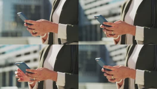 一名女商人在城市里使用智能手机的4k视频高清在线视频素材下载