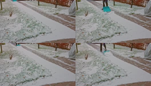 一个人用铲子在小巷里清理积雪。冬季概念背景。瑞典。高清在线视频素材下载