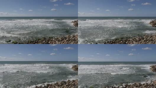 海浪拍打着海岸上的一块石头高清在线视频素材下载