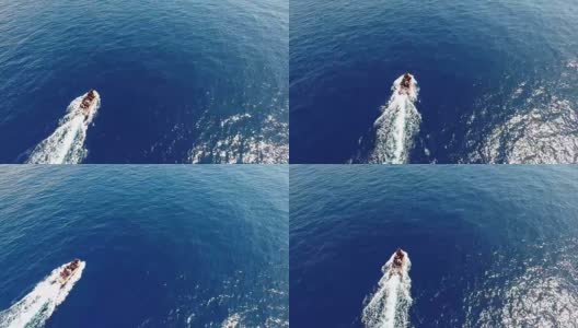 航拍:摩托艇驶过蓝色海面，留下白色的痕迹高清在线视频素材下载