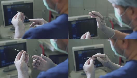 从个人角度看，医生在手术前用无菌手套夹住手术刀片。POV特写医疗器械在手，从后面看，设备在一个诊所和医院没有病人高清在线视频素材下载