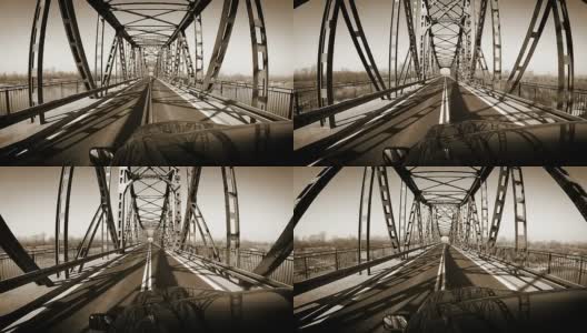 旧的米色深褐色:在车顶上的摄像车在钢桥上高清在线视频素材下载