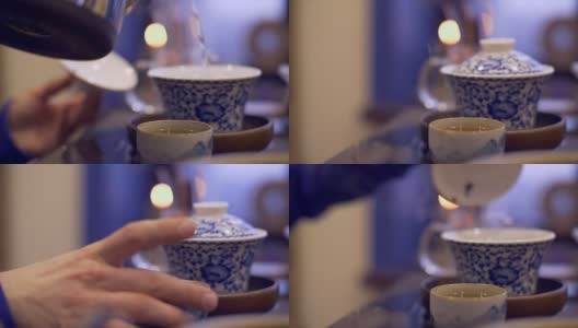 男性用手将热水倒入碗中冲泡茶叶。男子手拿茶杯高清在线视频素材下载