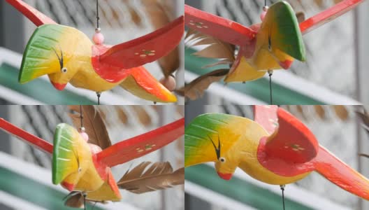 彩色鸟的木制风车运动雕塑在风中发展高清在线视频素材下载