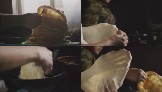 一个印第安人(纳瓦霍人)的女人的手形成一个生的玉米粉圆饼(炸面包)，而另一个女人取出一个熟的玉米粉圆饼，并把它放在一个完成的堆栈上，然后把一个生玉米粉圆饼放到室内炉子上的油高清在线视频素材下载