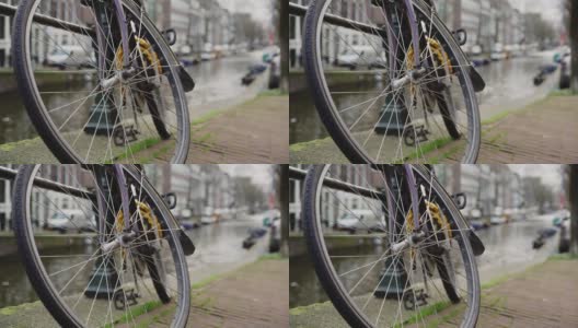 手持近距离拍摄的自行车车轮停在桥附近高清在线视频素材下载