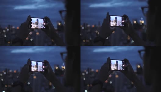 人们在一座建筑上拍摄城市的夜景。高清在线视频素材下载