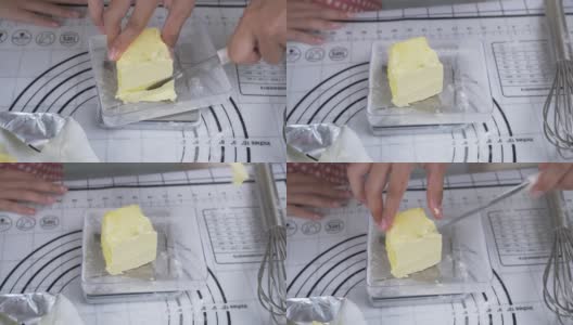 亚洲孩子在家里一起烤饼干前测量黄油，生活方式的概念。高清在线视频素材下载