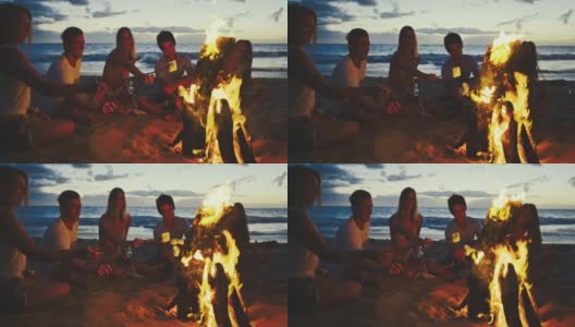 朋友们在篝火海滩聚会上放松高清在线视频素材下载