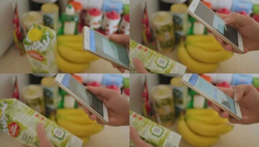 一名男子扫描超市果汁盒上的二维码。高清在线视频素材下载