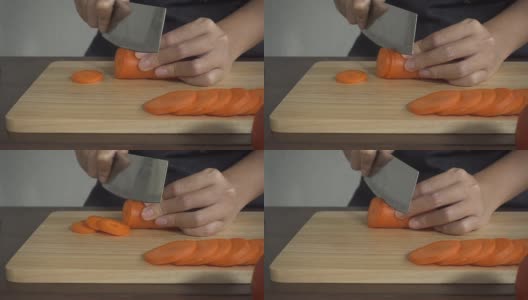 慢镜头-女人做健康的食物和切胡萝卜在厨房的砧板上。高清在线视频素材下载