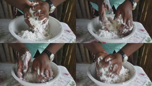 斐济土著妇女的手挤压椰子水果奶油在斐济高清在线视频素材下载