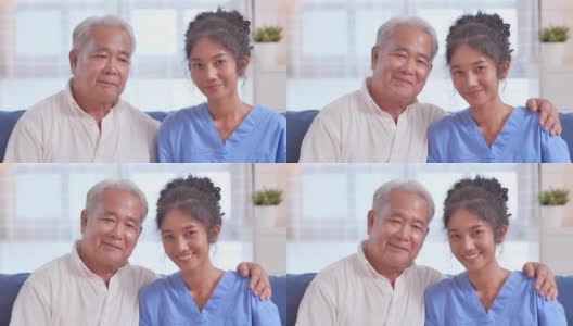 肖像快乐的志愿者年轻的黑人妇女护士看门人与亚洲老祖父病人，同时看在家里的相机。家庭工作室高清在线视频素材下载