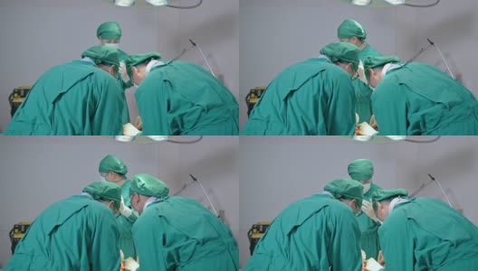 在医院的手术室里，外科医生们穿着手术服给一名严重受伤的病人做手术高清在线视频素材下载