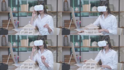 一位女建筑师使用虚拟现实头盔(VR Gear)来模拟室内设计和房屋建造。高清在线视频素材下载