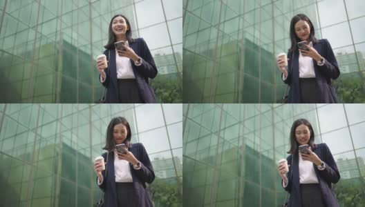 亚洲女商人使用智能手机进行社交媒体高清在线视频素材下载
