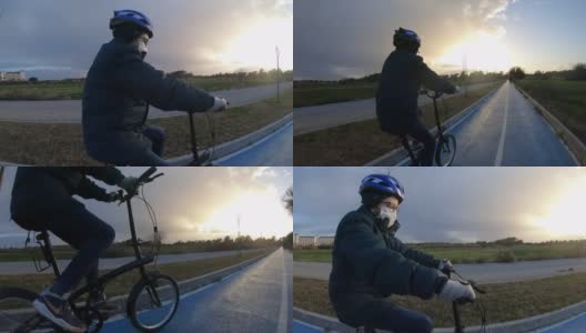男孩骑着自行车在日落前进来。高清在线视频素材下载