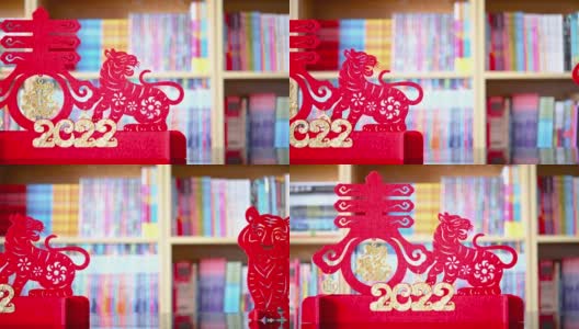 潘观中国新年老虎2022吉祥物剪纸在客厅的书架前，中文翻译是财富和春天没有标志没有商标高清在线视频素材下载