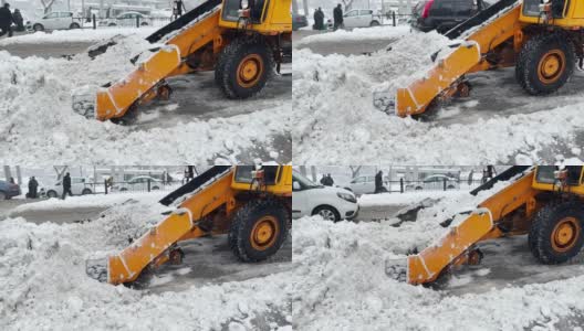 挖掘机，一辆汽车在清理城市街道上的积雪高清在线视频素材下载