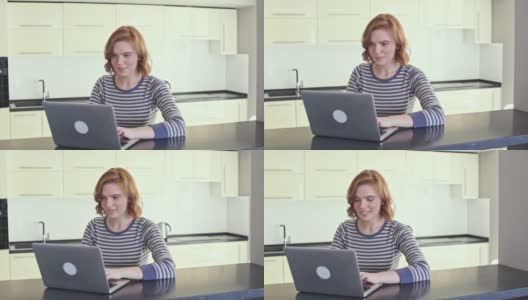 一个留着短发的漂亮姑娘正在用笔记本电脑聊天高清在线视频素材下载