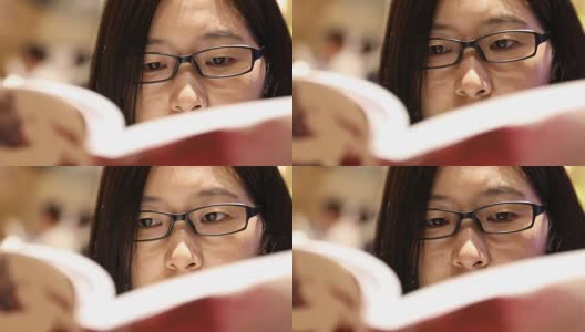 一个女人在图书馆看书高清在线视频素材下载