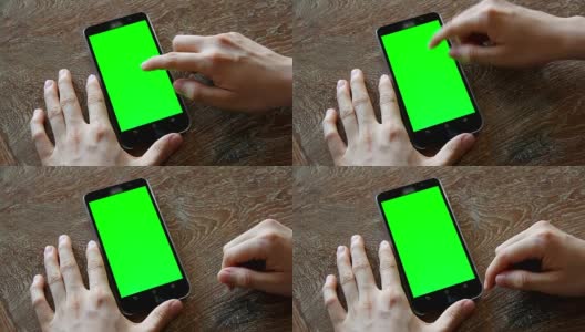 手用带有绿色屏幕的手机放在木桌上高清在线视频素材下载