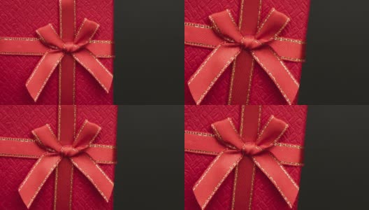 漂亮的红色礼品盒，黑色背景上有一个小蝴蝶结。一个伟大的礼物高清在线视频素材下载