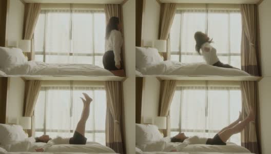 幸福快乐的亚洲女女人早晨在床上跳跃与兴奋的新鲜与晨光从窗口的阳光，幸福女在床上跳跃高清在线视频素材下载