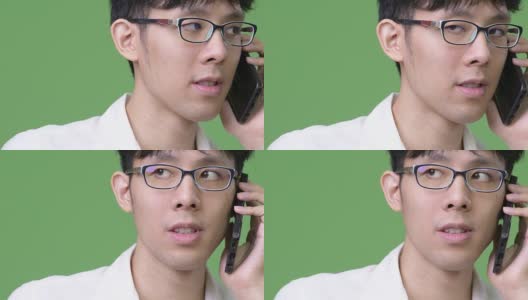 年轻的亚洲商人一边打电话一边思考高清在线视频素材下载