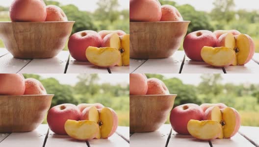 以自然为背景的木桌上的红苹果高清在线视频素材下载