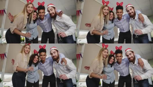 快乐的商业人士戴着圣诞帽在办公室里自拍，看着相机微笑着庆祝新年。Slowmotion拍摄高清在线视频素材下载