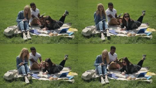 三个学生在校园草坪上学习。高清在线视频素材下载