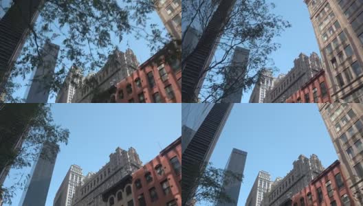 低角度视角:路过令人惊叹的摩天大楼，历史建筑和公寓高清在线视频素材下载