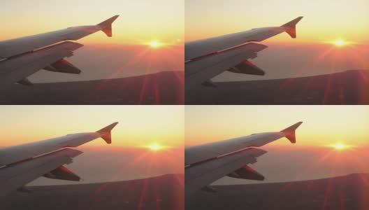 从飞机窗口的机翼看日落到太阳从右到左高清在线视频素材下载
