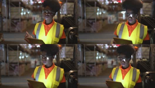 严肃的年轻非洲工人在仓库使用数字平板电脑高清在线视频素材下载