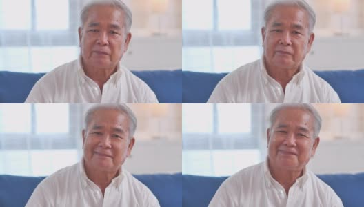 肖像自信的亚洲老爷爷微笑着与镜头交流，独自在家摆姿势，快乐的情绪享受成功的生活方式。在视频会议技术上的社交距离。家庭工作室高清在线视频素材下载