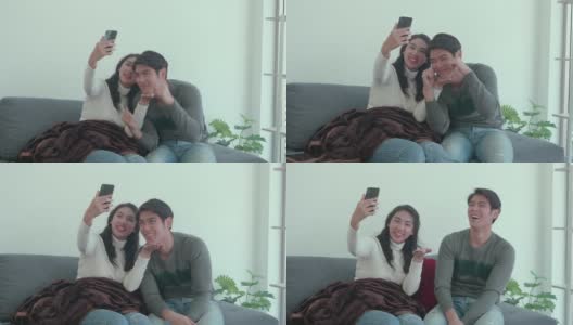 亚洲年轻夫妇在客厅使用手机高清在线视频素材下载