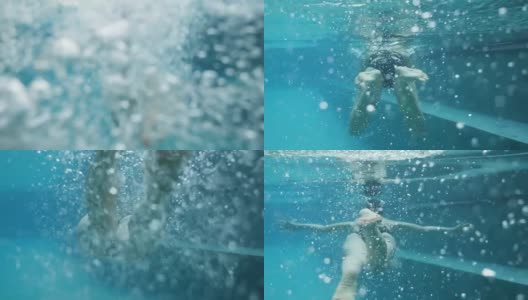 一个女人游泳的水下镜头高清在线视频素材下载