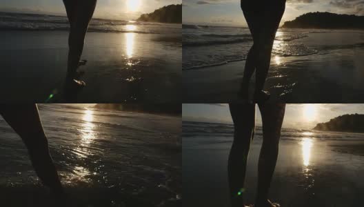 一个女人在巴西的海滩上走日落高清在线视频素材下载