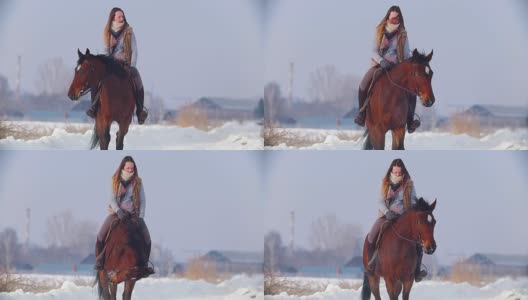 美丽的长发女子骑着一匹棕色的马穿过森林里的深雪堆高清在线视频素材下载