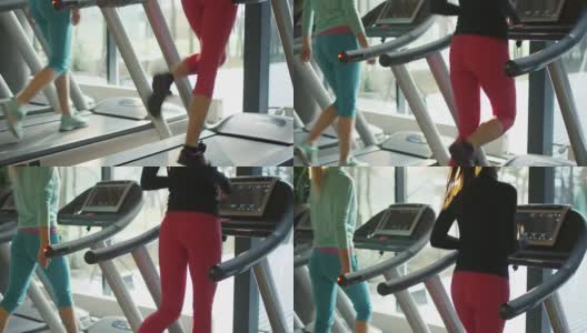 迷人的白人女孩在跑步机上跑步粉红衣服在体育健身馆。高清在线视频素材下载
