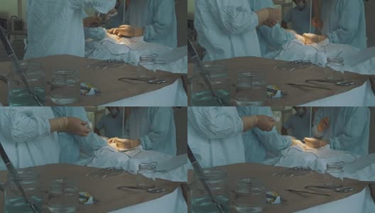 在手术室里，外科手术工具被交给外科医生高清在线视频素材下载