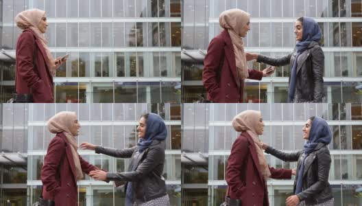 两位英国穆斯林女性朋友在办公室外聚会高清在线视频素材下载
