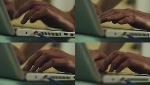 一个年轻的白种人在笔记本电脑上打字高清在线视频素材下载