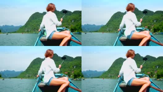 后视图金发女人在河船上自拍高清在线视频素材下载