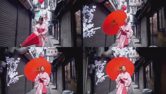 快乐年轻美丽的亚洲女性穿着传统的日本和服，手拿红纸伞微笑着走在日本东京新宿地区的街道上高清在线视频素材下载