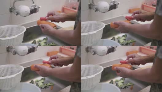 女人在家里用菜刀削胡萝卜和切胡萝卜。高清在线视频素材下载