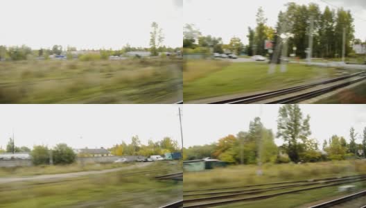 从一列行驶的火车的窗口看过去，快速移动的一个小村庄，一个十字路口，一个车站，黄色的树木在一个多云的秋天的一天高清在线视频素材下载