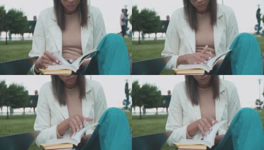 混血女子读书，坐在公园里，大学教育，知识高清在线视频素材下载